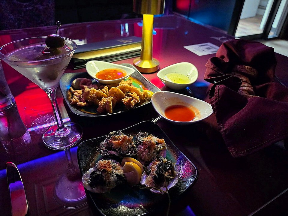 Martini, brass lamp, sauces, and hors d'oeuvres set for table service at CK Downtown