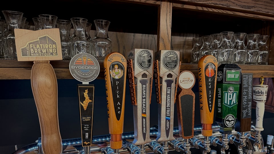 CK Downtown draft beer taps and glassware at the bar