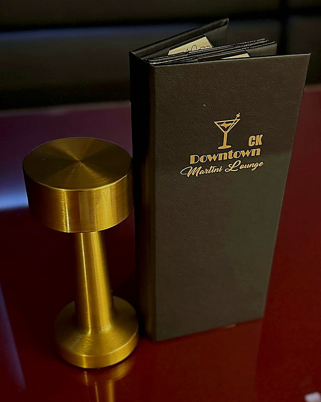 CK Downtown lounge menu and brass table lamp